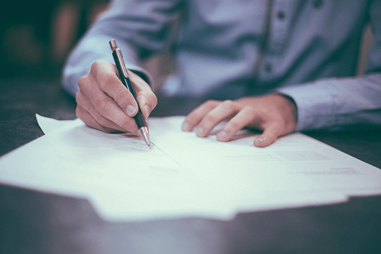 men writing with a pen